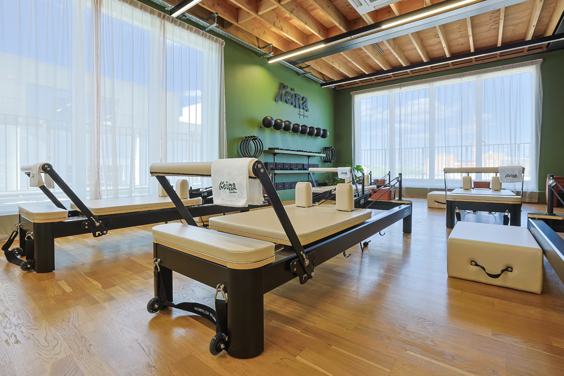 Sunlit reformer studio with branded towels